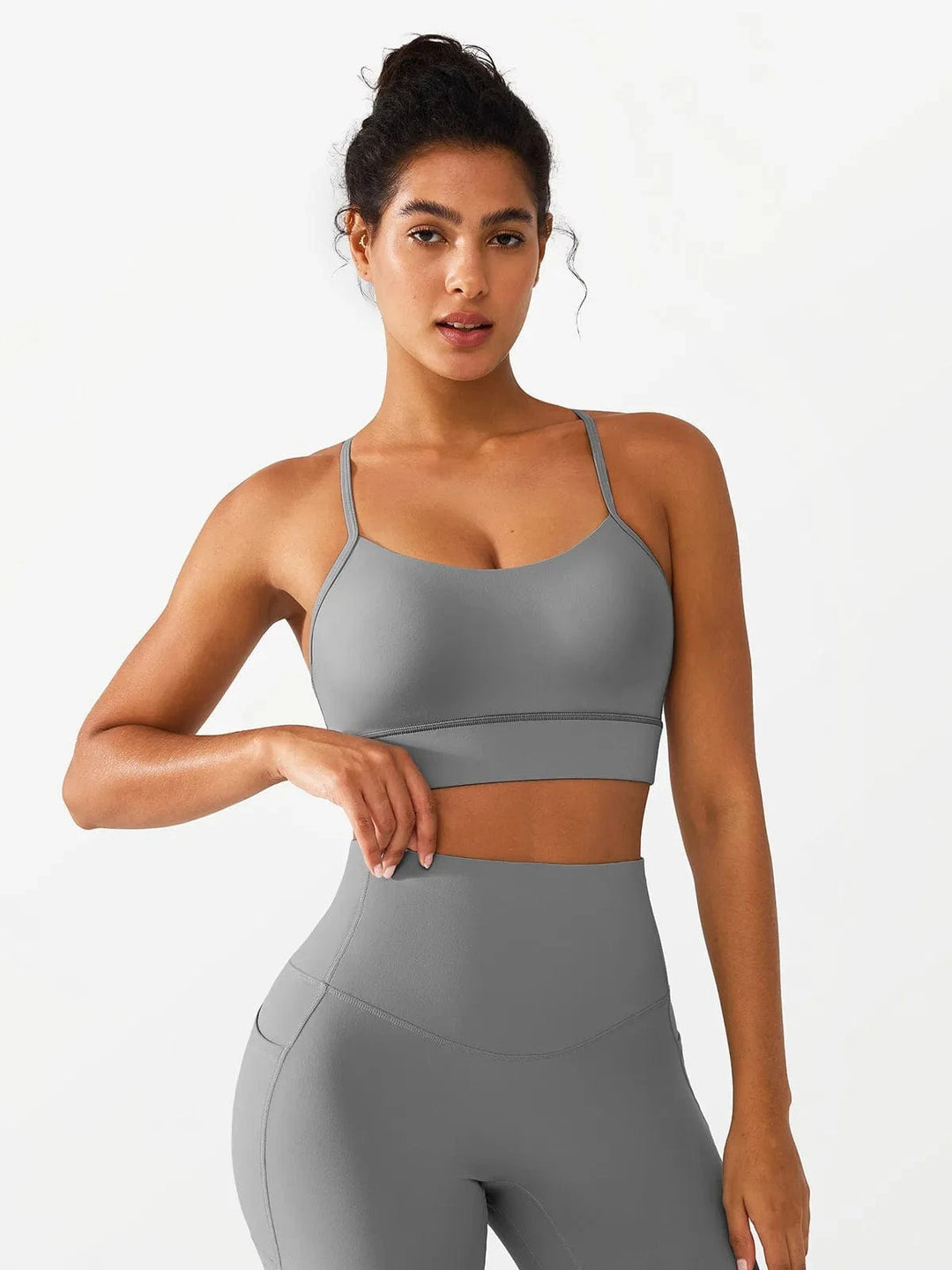 A model wearing a BRXL® Flow Y Racerback Bra with Low Cut and Spaghetti Straps in