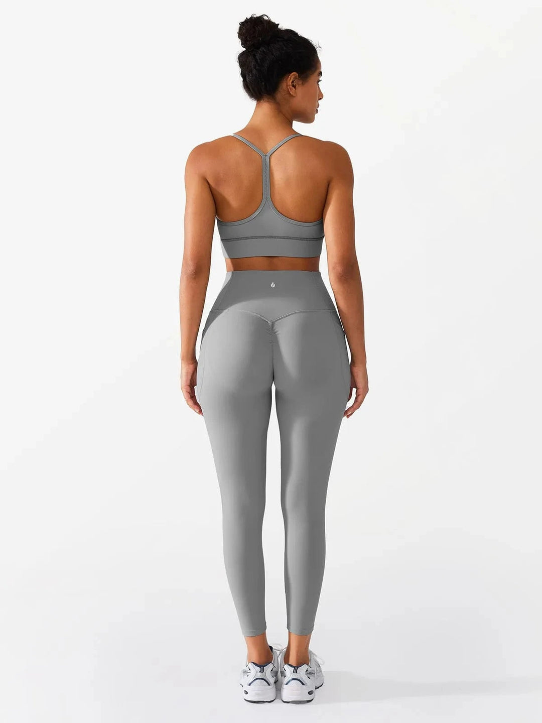 A model wearing a BRXL® Flow Y Racerback Bra with Low Cut and Spaghetti Straps in