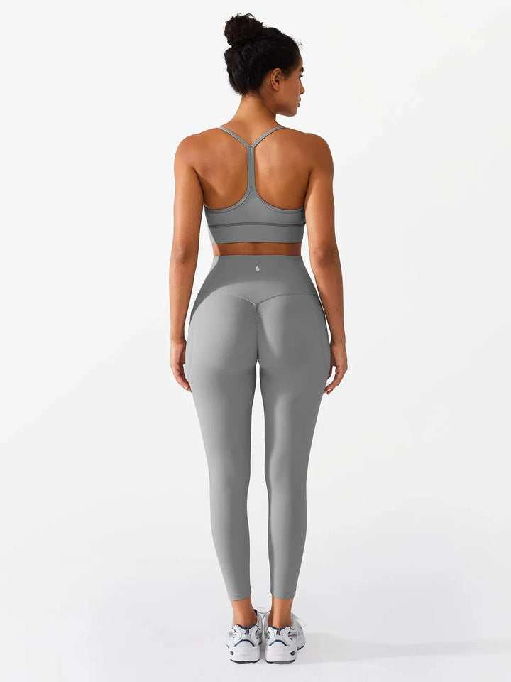 A model wearing a BRXL® Flow Y Racerback Bra with Low Cut and Spaghetti Straps in