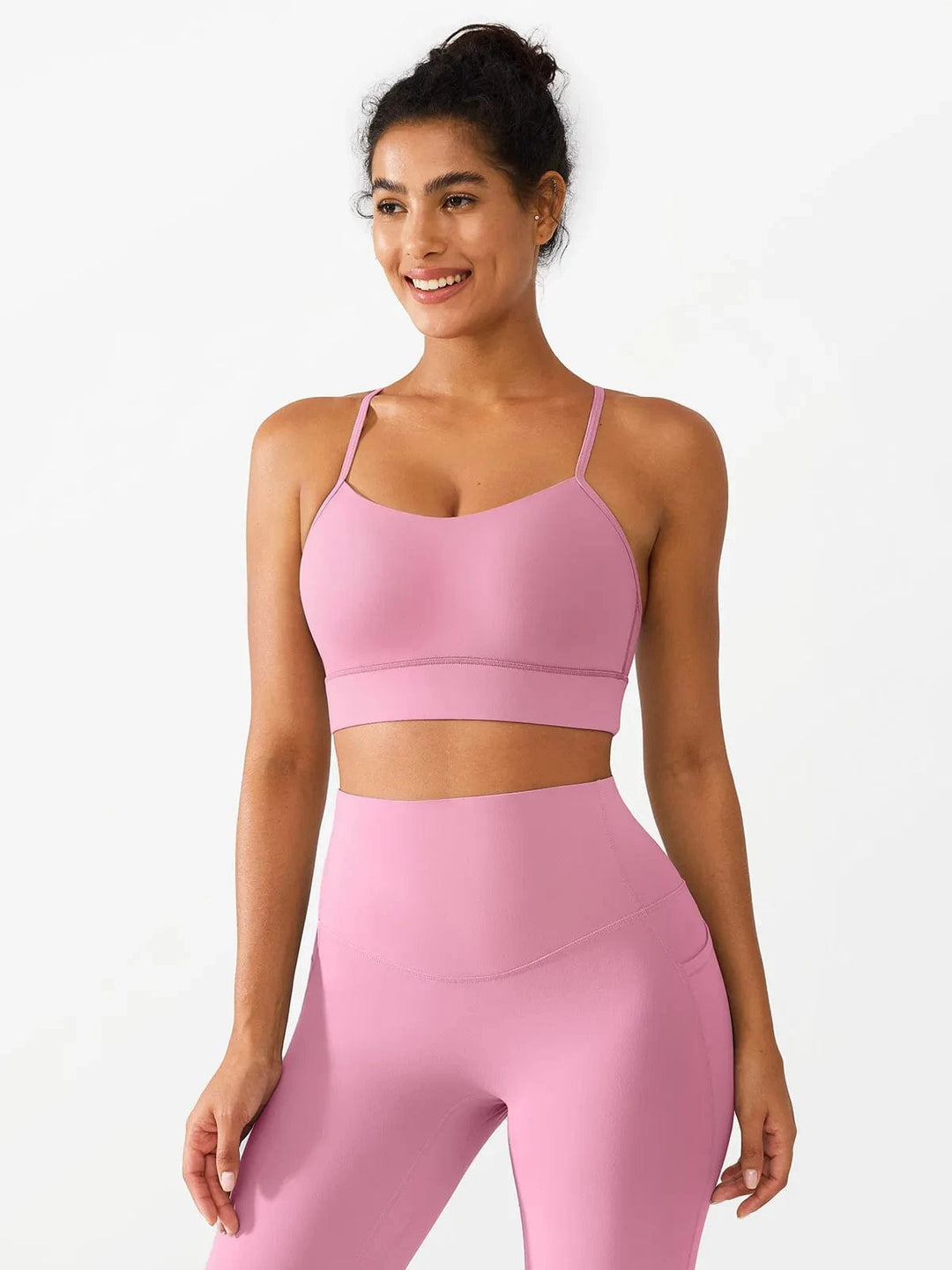 A model wearing a BRXL® Flow Y Racerback Bra with Low Cut and Spaghetti Straps in Pink / XS