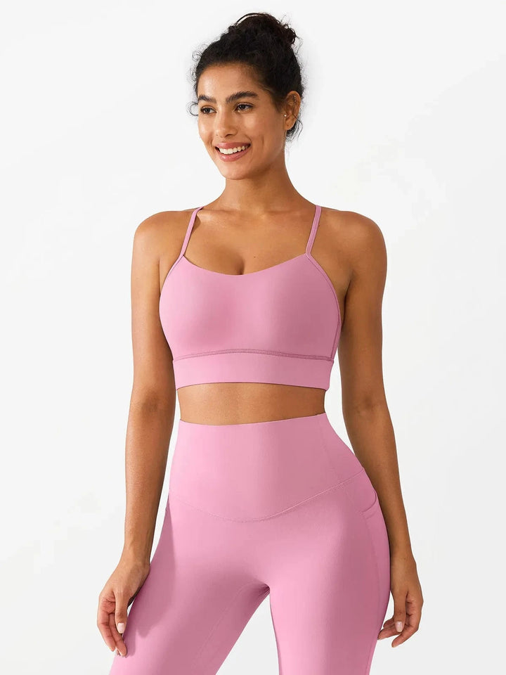 A model wearing a BRXL® Flow Y Racerback Bra with Low Cut and Spaghetti Straps in Pink / XS