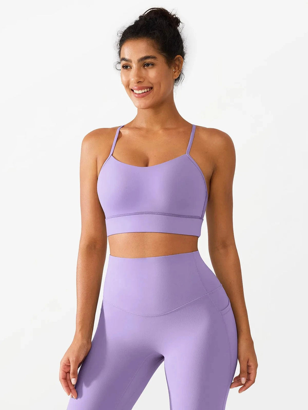 A model wearing a BRXL® Flow Y Racerback Bra with Low Cut and Spaghetti Straps in Purple / XS