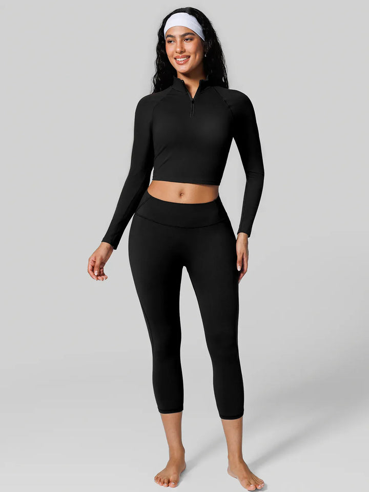 A model wearing a BRXL® Half Front Zipper Cropped Top Side Pockets Fleece Lined Leggings Set in