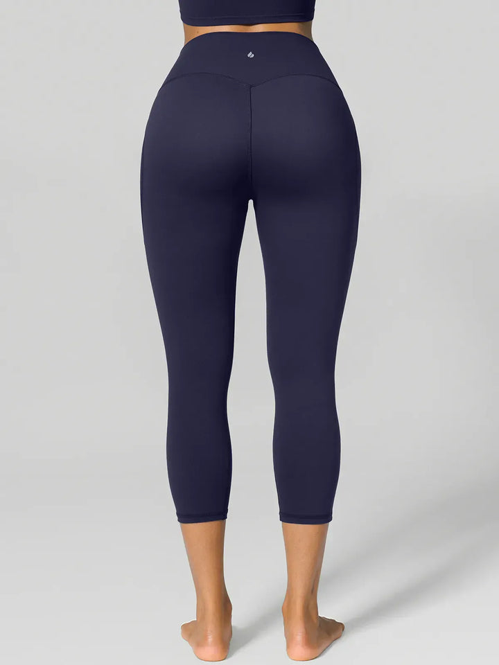 A model wearing a BRXL® Half Front Zipper Cropped Top Side Pockets Fleece Lined Leggings Set in