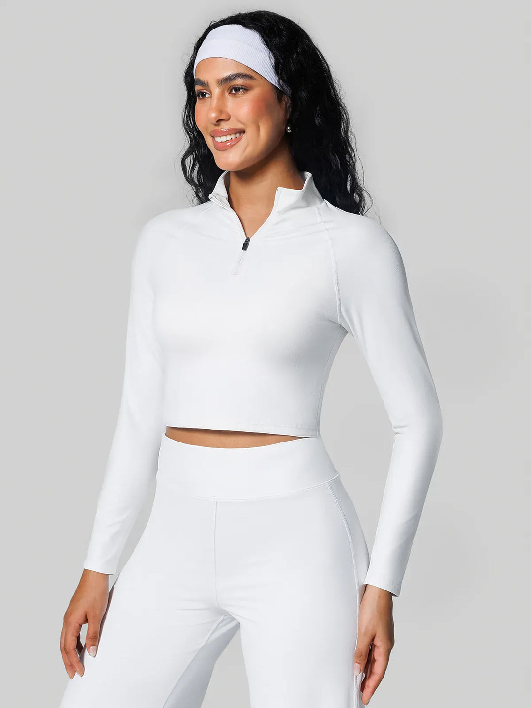 A model wearing a BRXL® Half Front Zipper Cropped Top Side Pockets Fleece Lined Leggings Set in