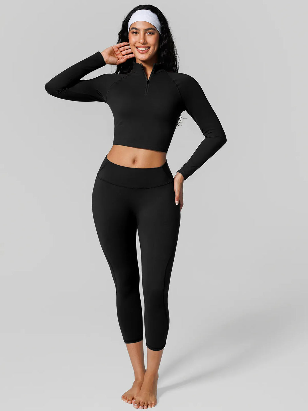 A model wearing a BRXL® Half Front Zipper Cropped Top Side Pockets Fleece Lined Leggings Set in Set / Black / XS