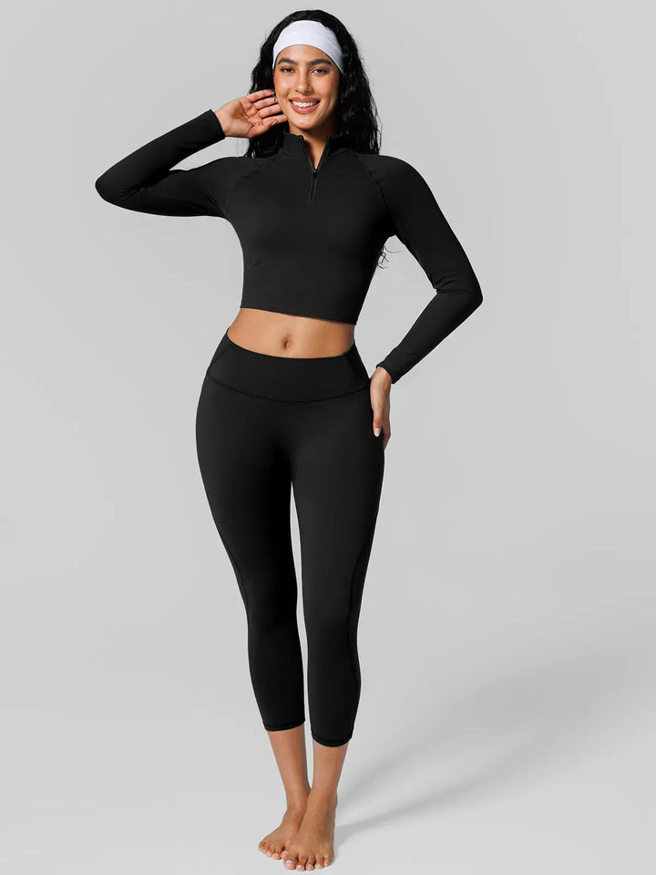 A model wearing a BRXL® Half Front Zipper Cropped Top Side Pockets Fleece Lined Leggings Set in Set / Black / XS