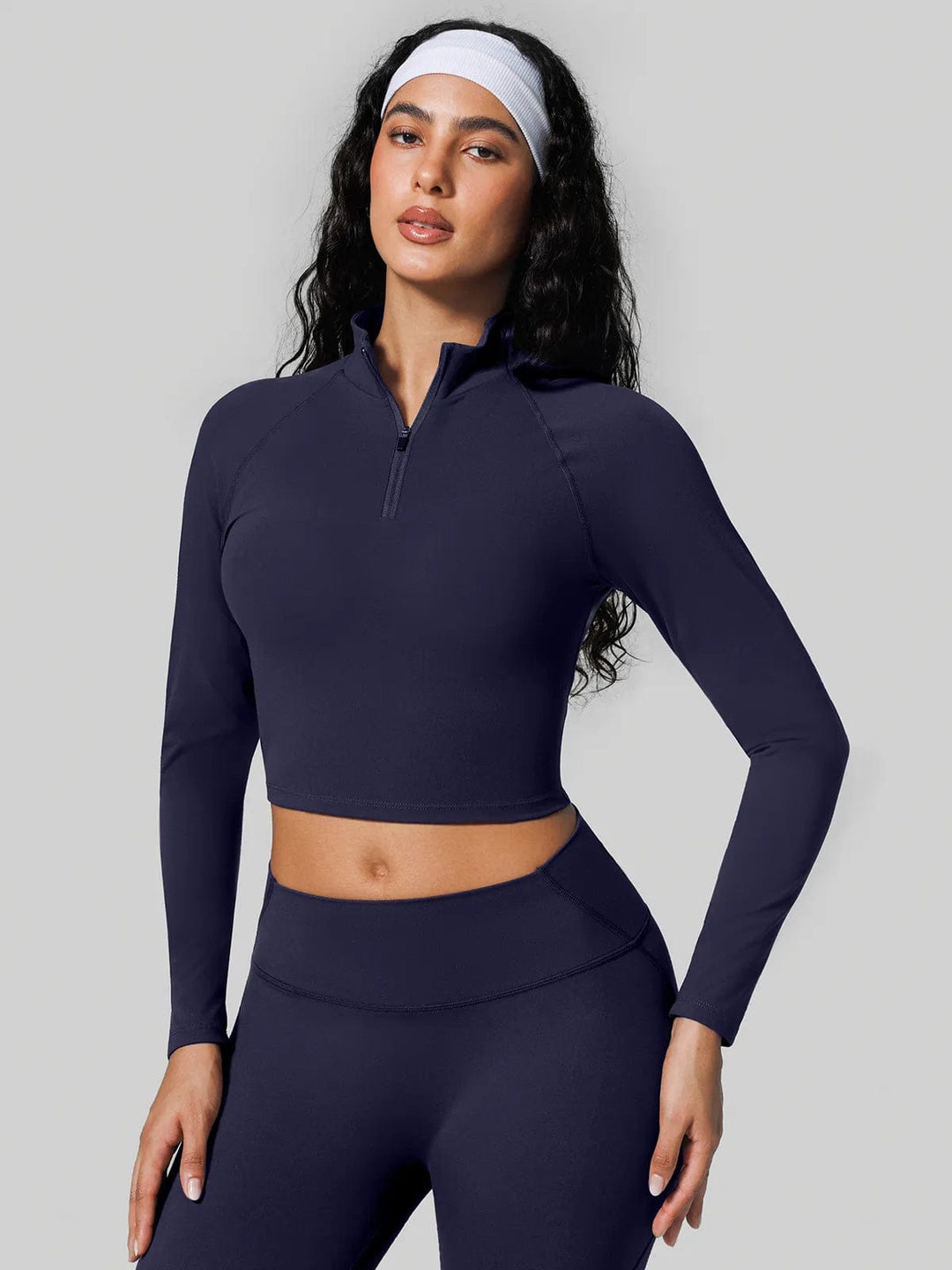 A model wearing a BRXL® Half Front Zipper Cropped Top Side Pockets Fleece Lined Leggings Set in Top / Blue / XS