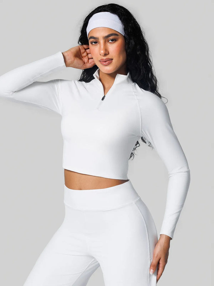 A model wearing a BRXL® Half Front Zipper Cropped Top Side Pockets Fleece Lined Leggings Set in Top / White / XS