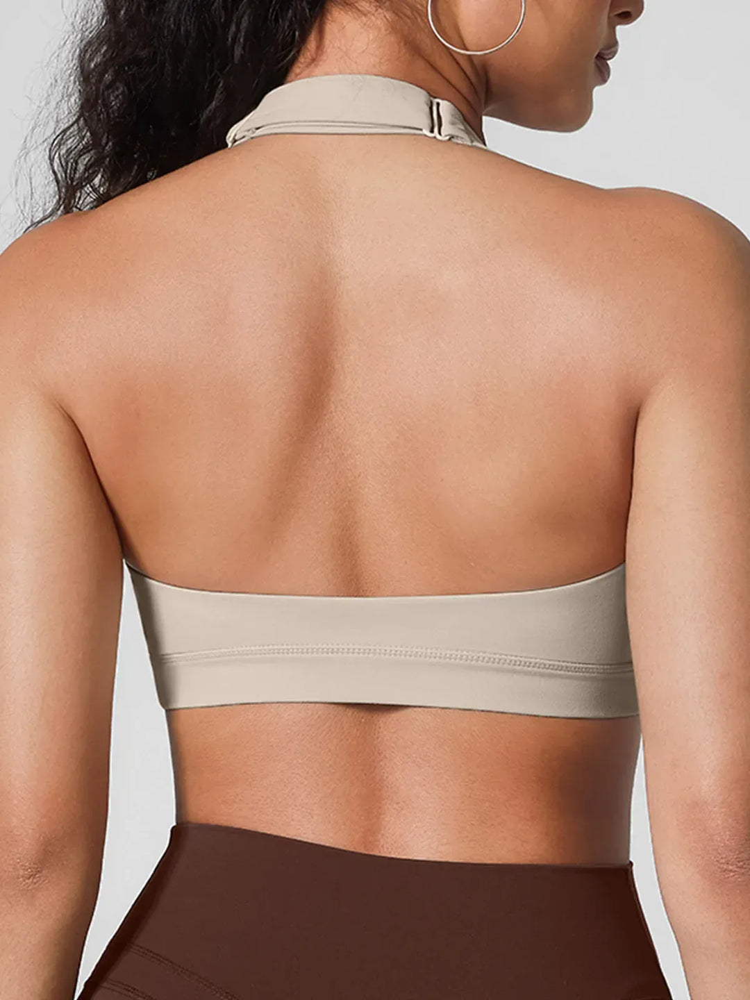 A model wearing a BRXL® Halter-neck Yoga Bra in