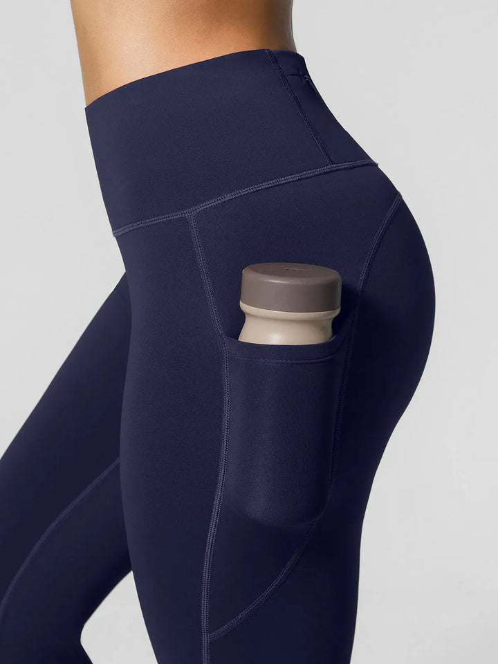 A model wearing a BRXL® High Rise Side Pockets Fleece Lined Leggings in