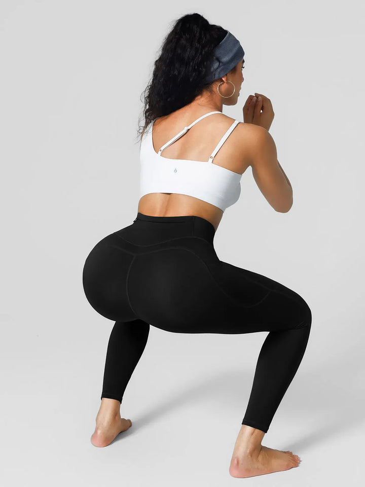 A model wearing a BRXL® High Rise Side Pockets Fleece Lined Leggings in