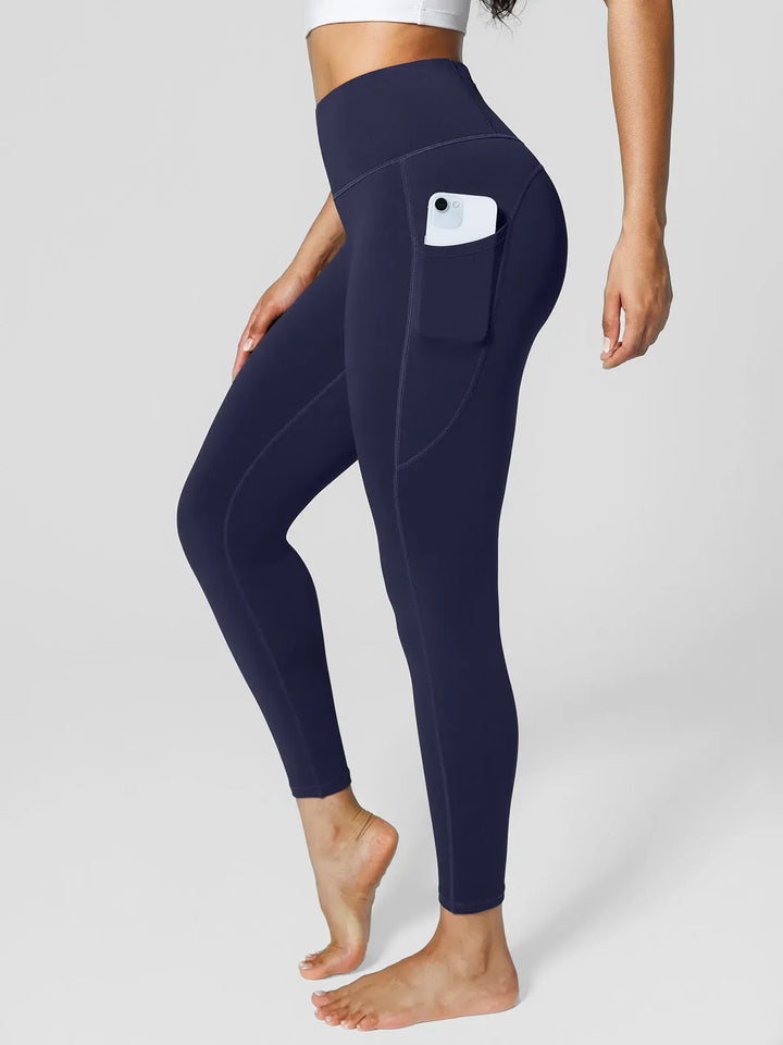 A model wearing a BRXL® High Rise Side Pockets Fleece Lined Leggings in Blue / XS
