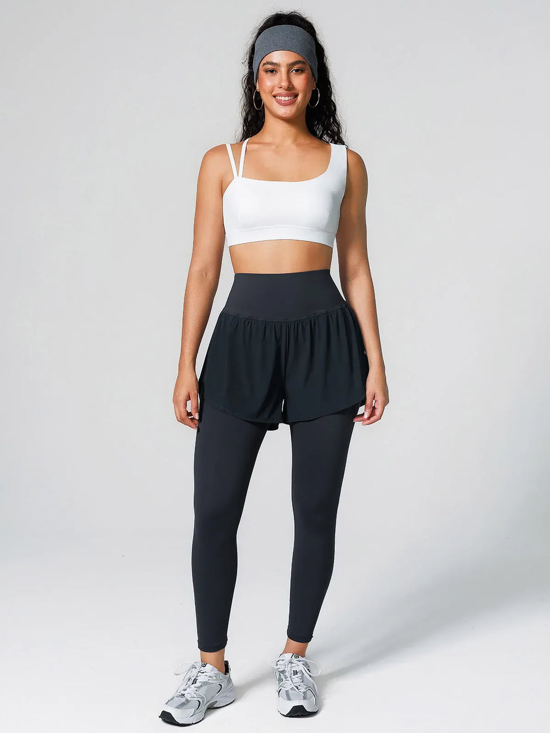 A model wearing a BRXL® Layered Combo Short Leggings in