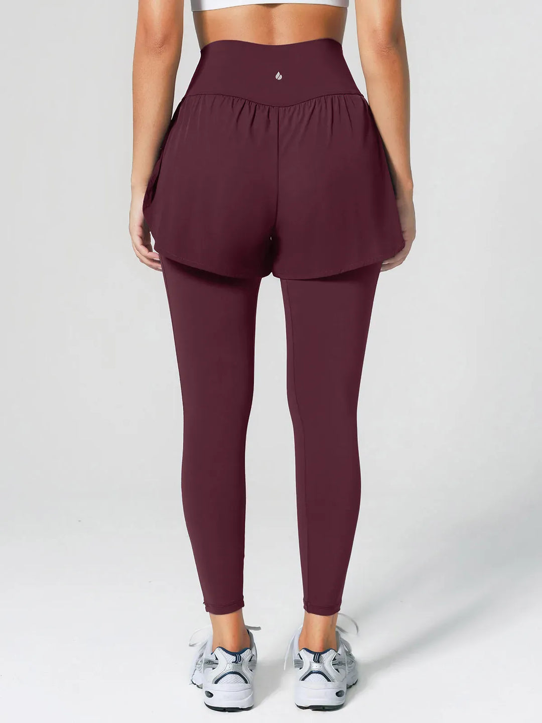 A model wearing a BRXL® Layered Combo Short Leggings in