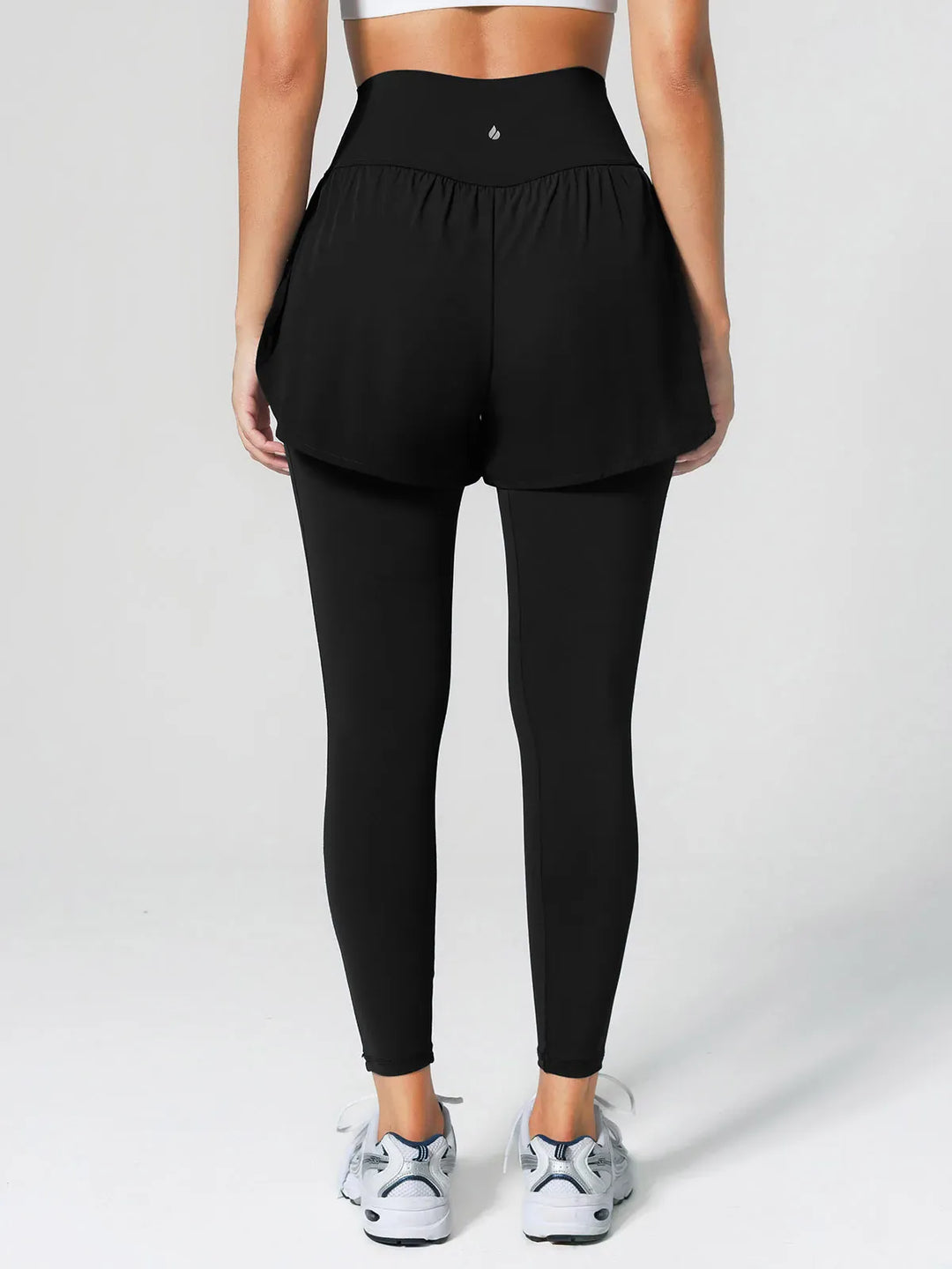 A model wearing a BRXL® Layered Combo Short Leggings in