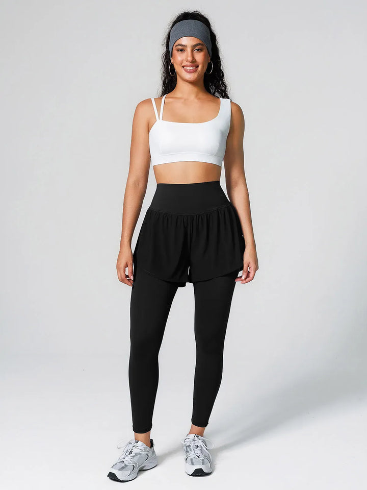 A model wearing a BRXL® Layered Combo Short Leggings in