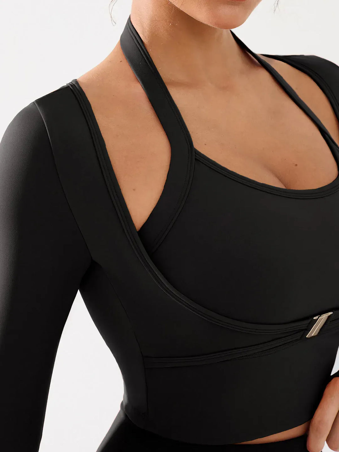 A model wearing a BRXL® Long Sleeve Halter Shrug Top with Buckle and Thumbhole in