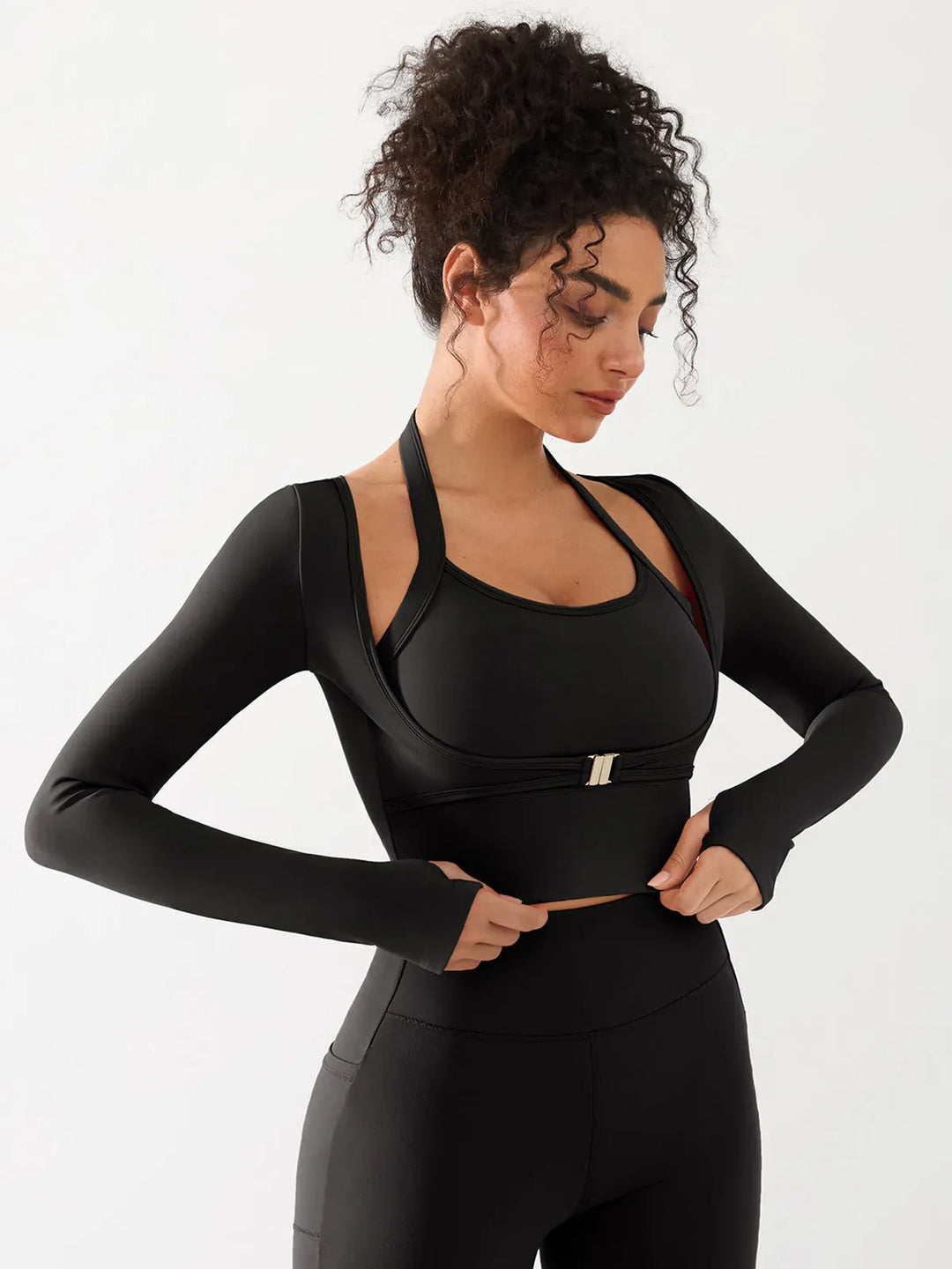 A model wearing a BRXL® Long Sleeve Halter Shrug Top with Buckle and Thumbhole in