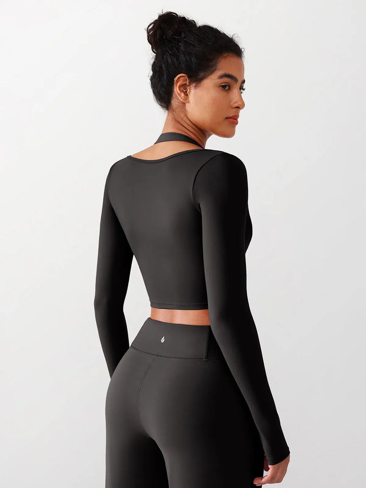 A model wearing a BRXL® Long Sleeve Halter Shrug Top with Buckle and Thumbhole in