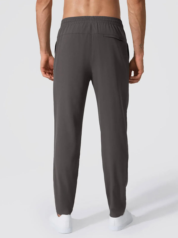 A model wearing a BRXL® Men’s  Adjustable Waist Tapered Activewear Joggers in