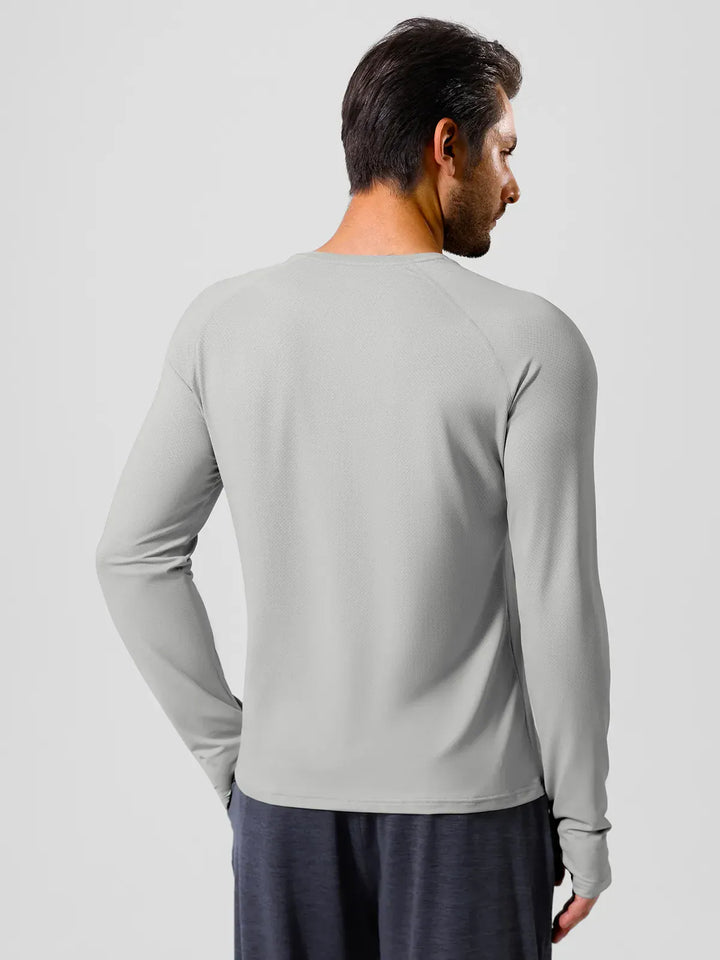 A model wearing a BRXL® Men’s Long Sleeve Thumbhole Activewear Shirt in