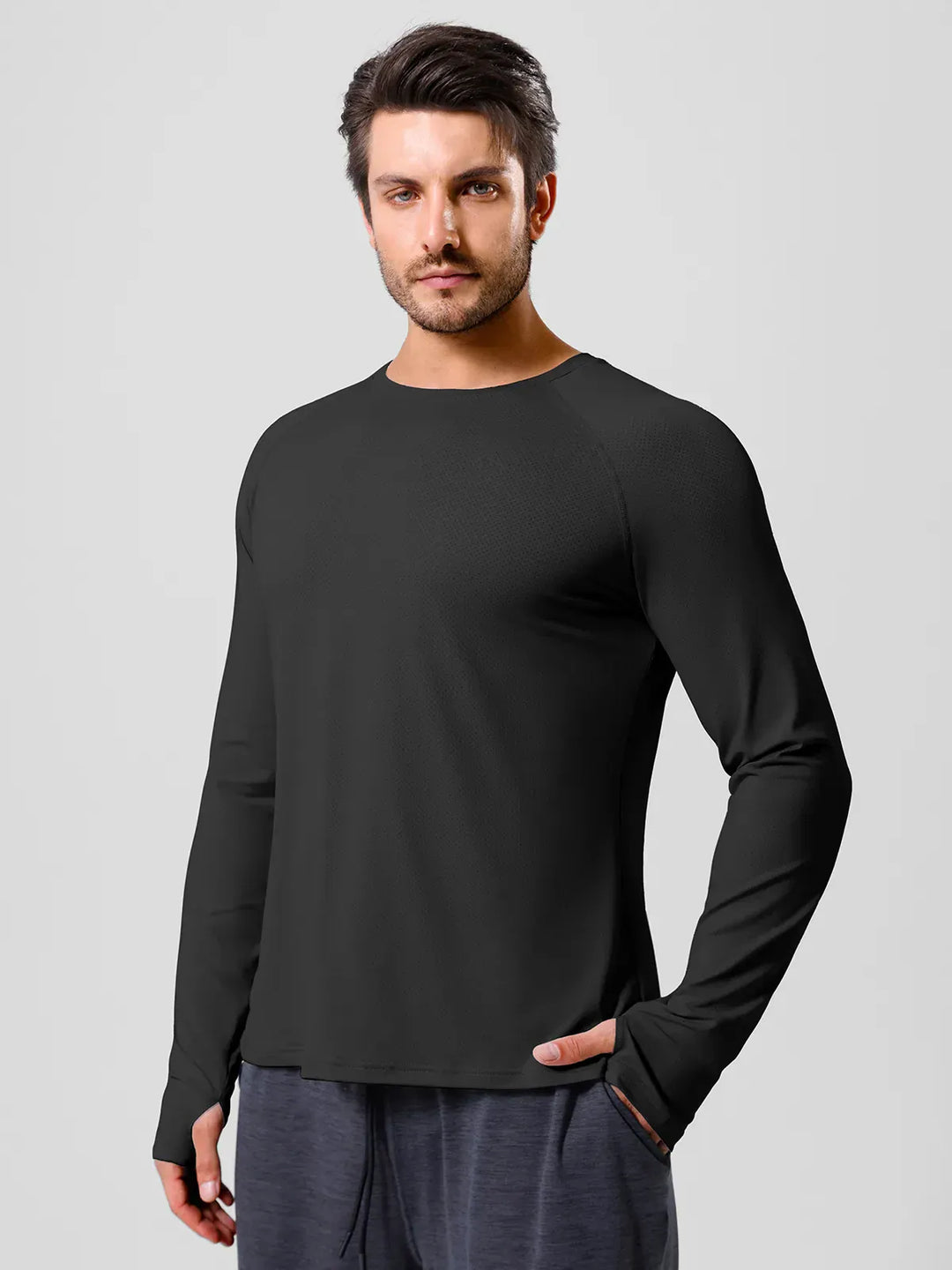 A model wearing a BRXL® Men’s Long Sleeve Thumbhole Activewear Shirt in
