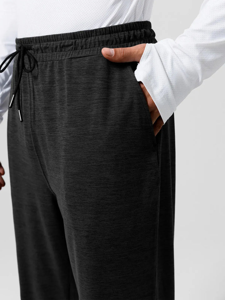 A model wearing a BRXL® Men’s Smooth Four Pockets Tapered Joggers in