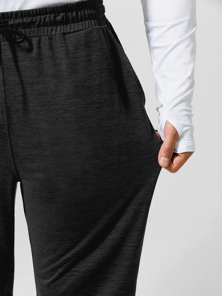 A model wearing a BRXL® Men’s Smooth Four Pockets Tapered Joggers in