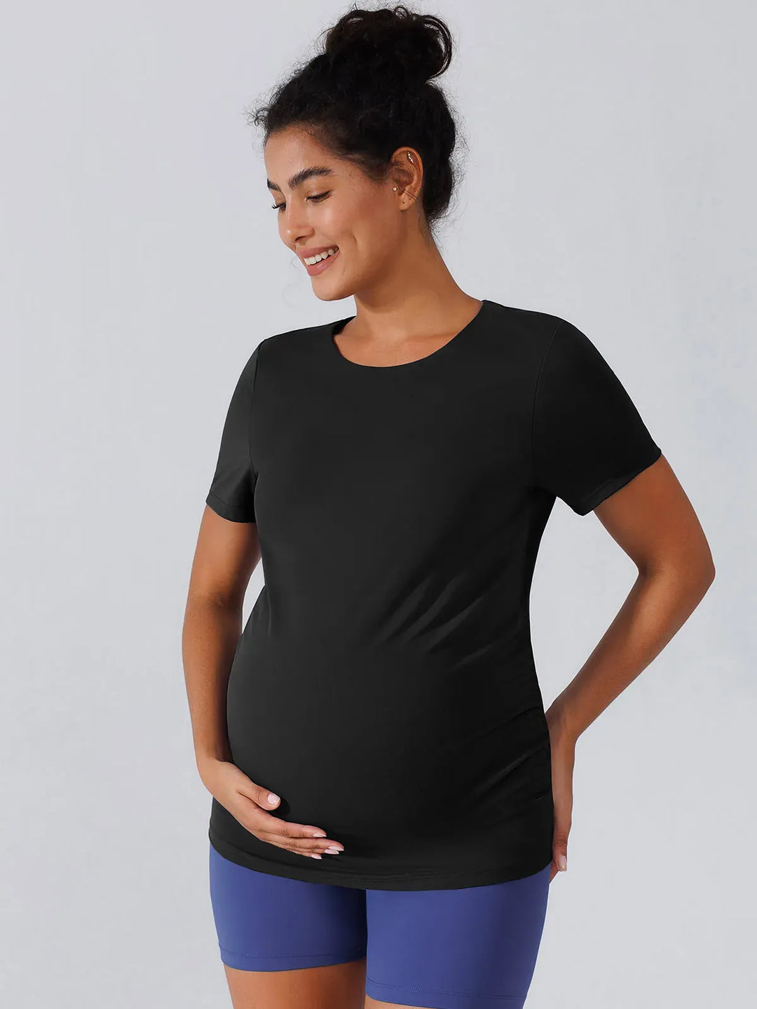 A model wearing a BRXL® Ruched Maternity T Shirts with Shelf Bra in