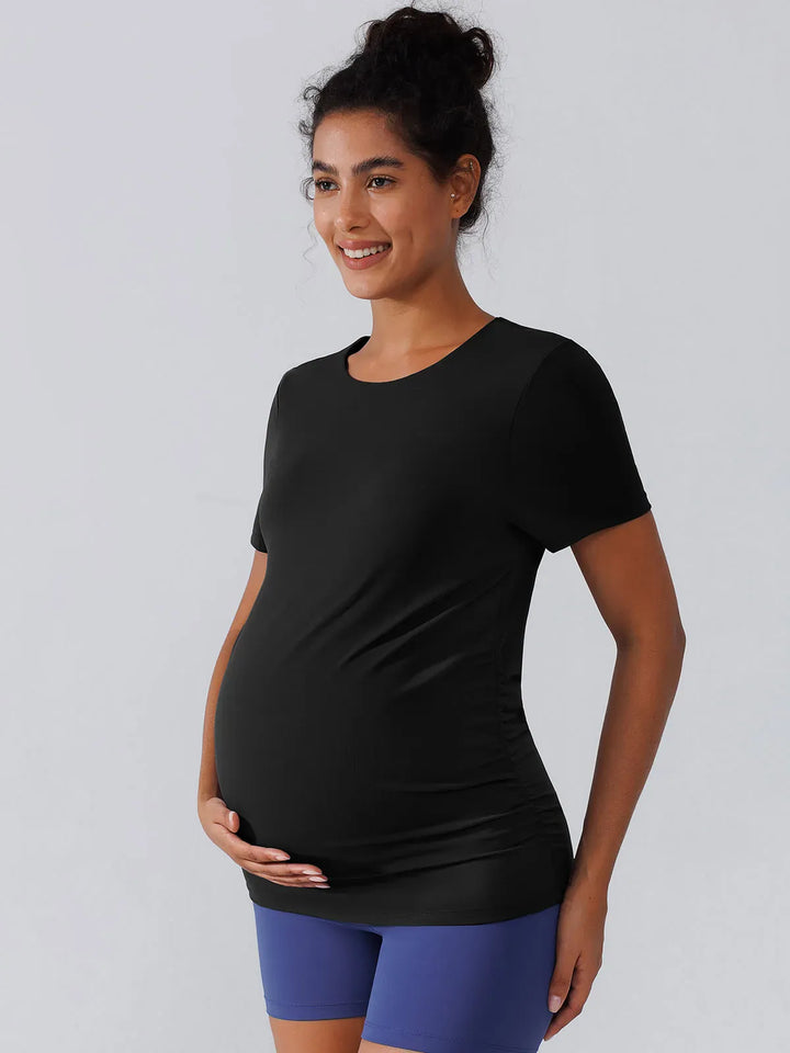 A model wearing a BRXL® Ruched Maternity T Shirts with Shelf Bra in