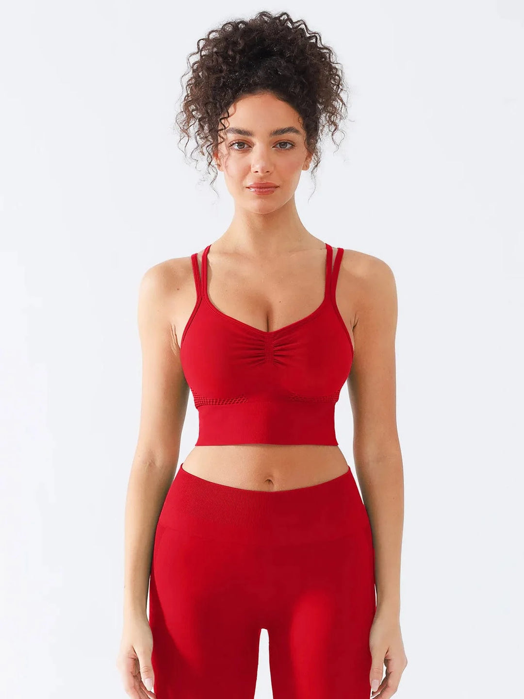 A model wearing a BRXL® Seamless Criss Cross Spaghetti Racerback Sports Bra in