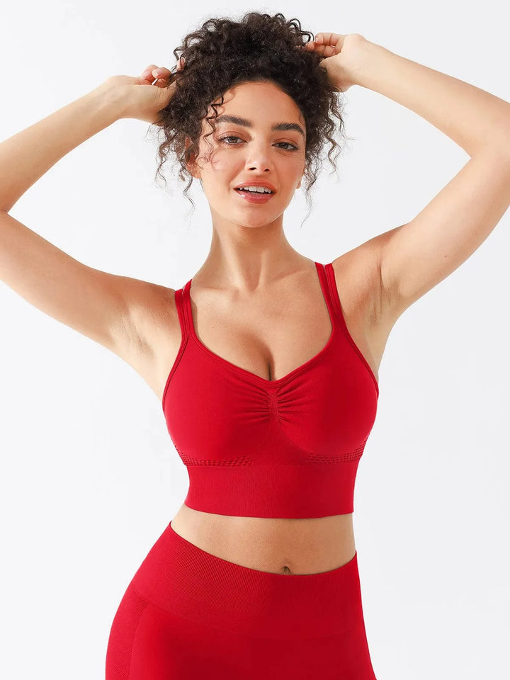 A model wearing a BRXL® Seamless Criss Cross Spaghetti Racerback Sports Bra in