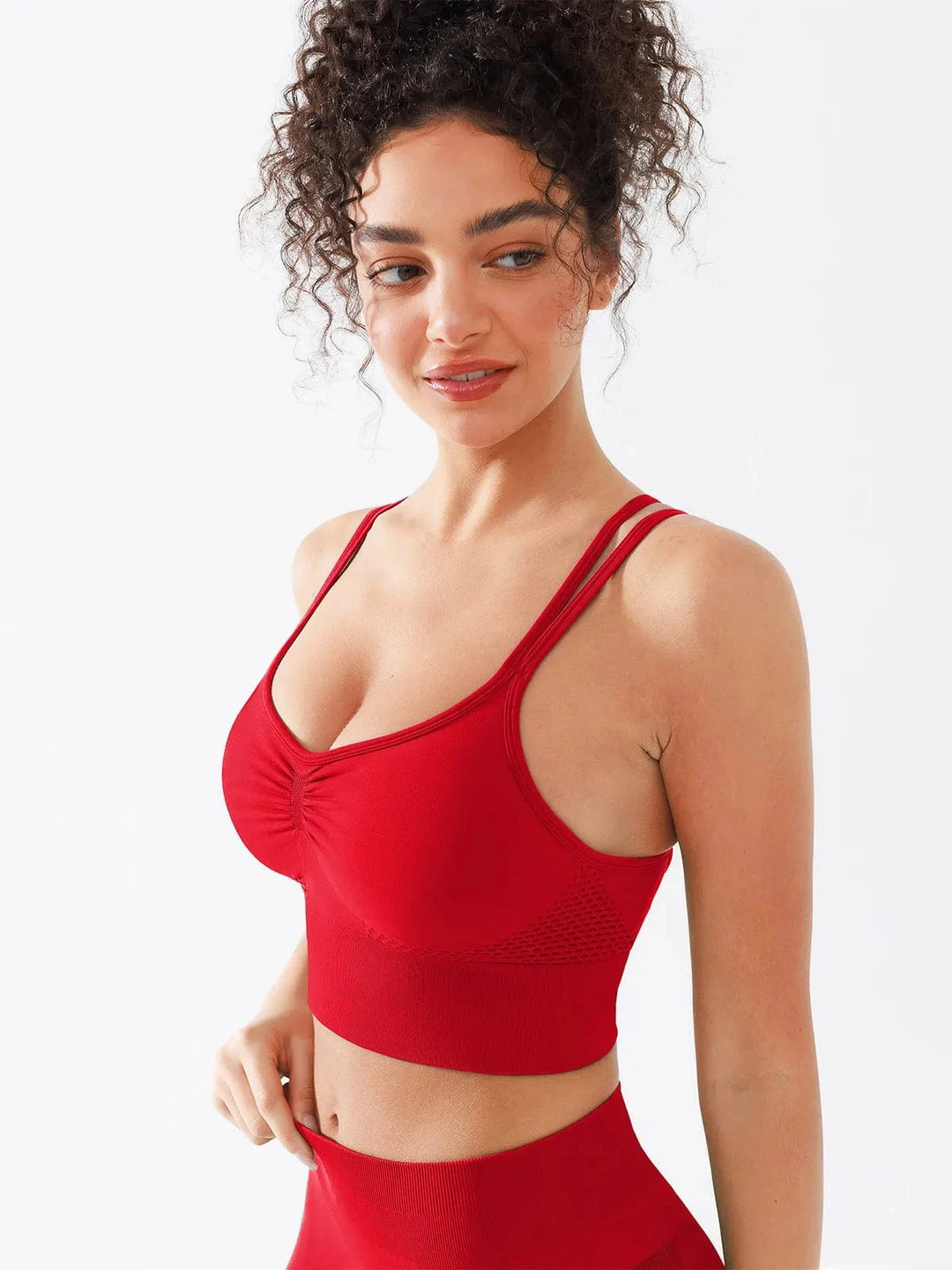A model wearing a BRXL® Seamless Criss Cross Spaghetti Racerback Sports Bra in