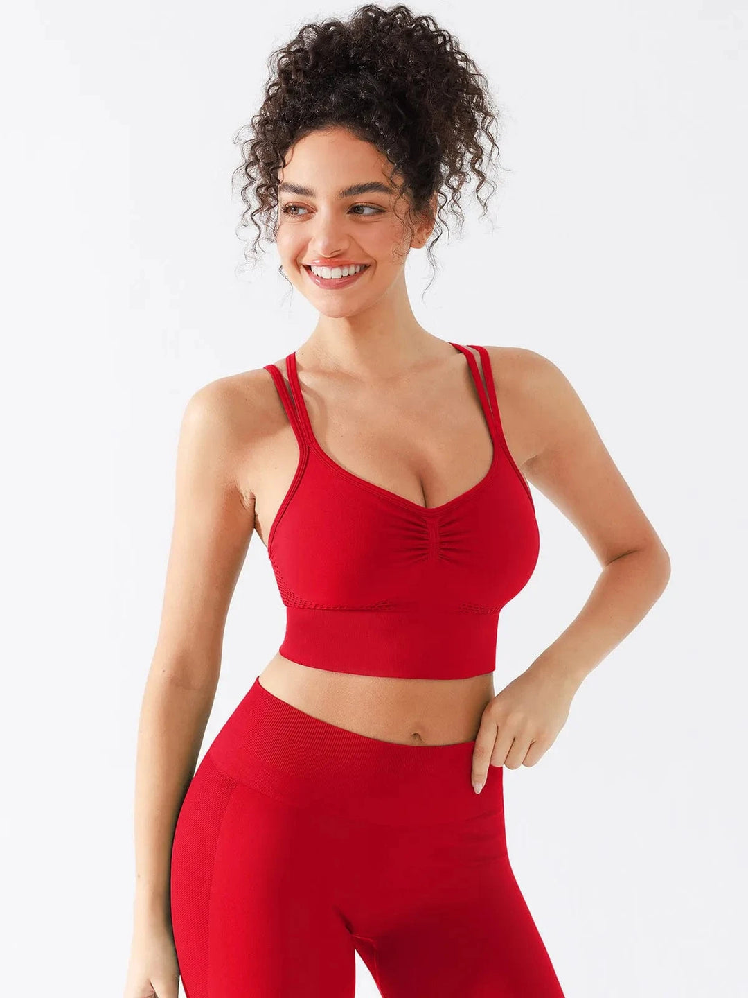 A model wearing a BRXL® Seamless Criss Cross Spaghetti Racerback Sports Bra in
