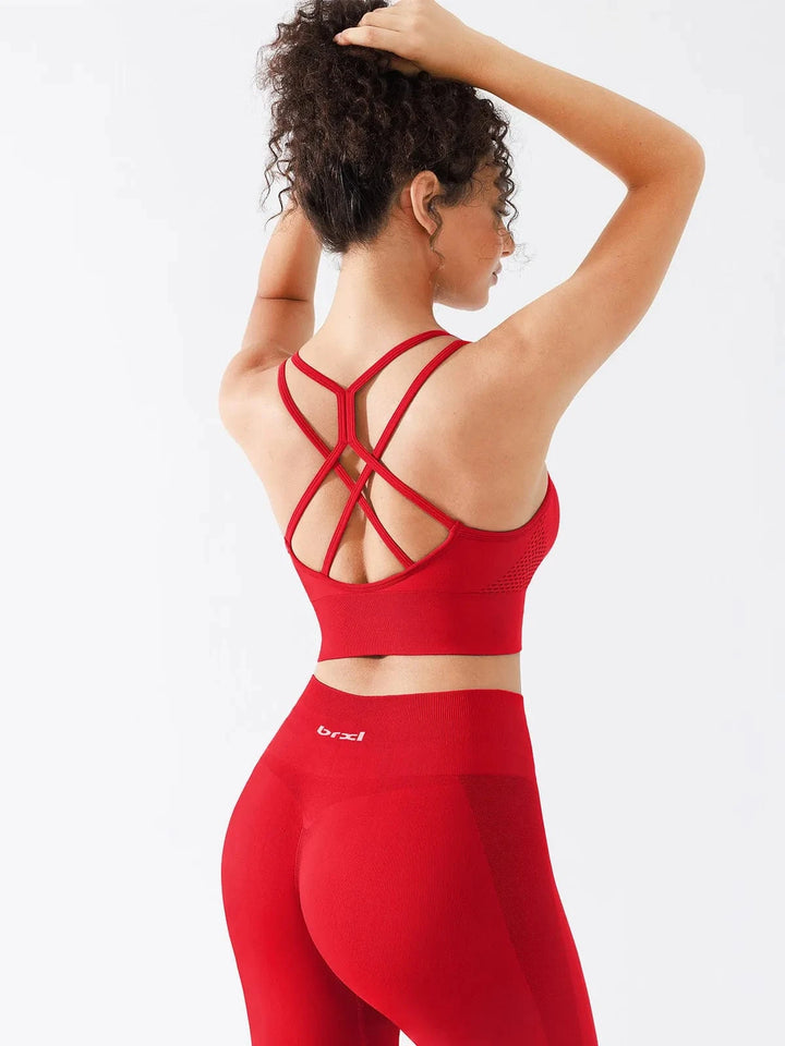 A model wearing a BRXL® Seamless Criss Cross Spaghetti Racerback Sports Bra in