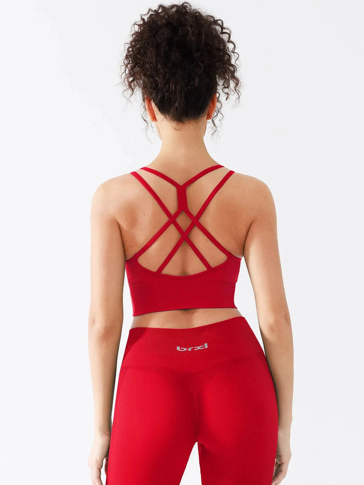 A model wearing a BRXL® Seamless Criss Cross Spaghetti Racerback Sports Bra in