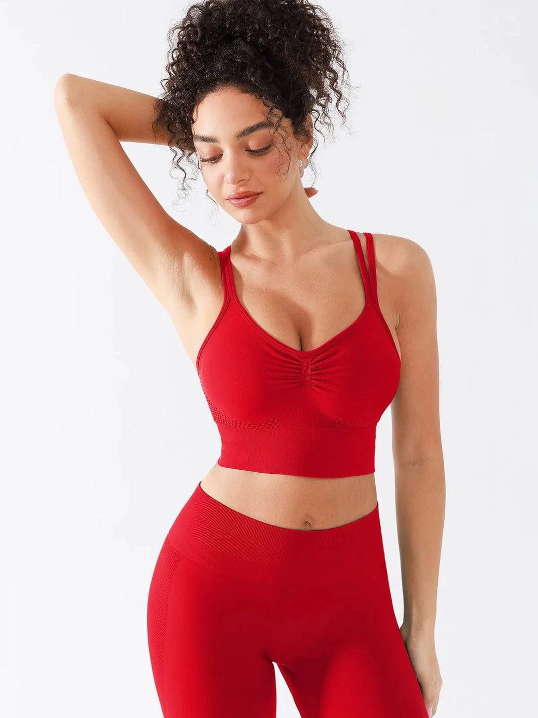 A model wearing a BRXL® Seamless Criss Cross Spaghetti Racerback Sports Bra in