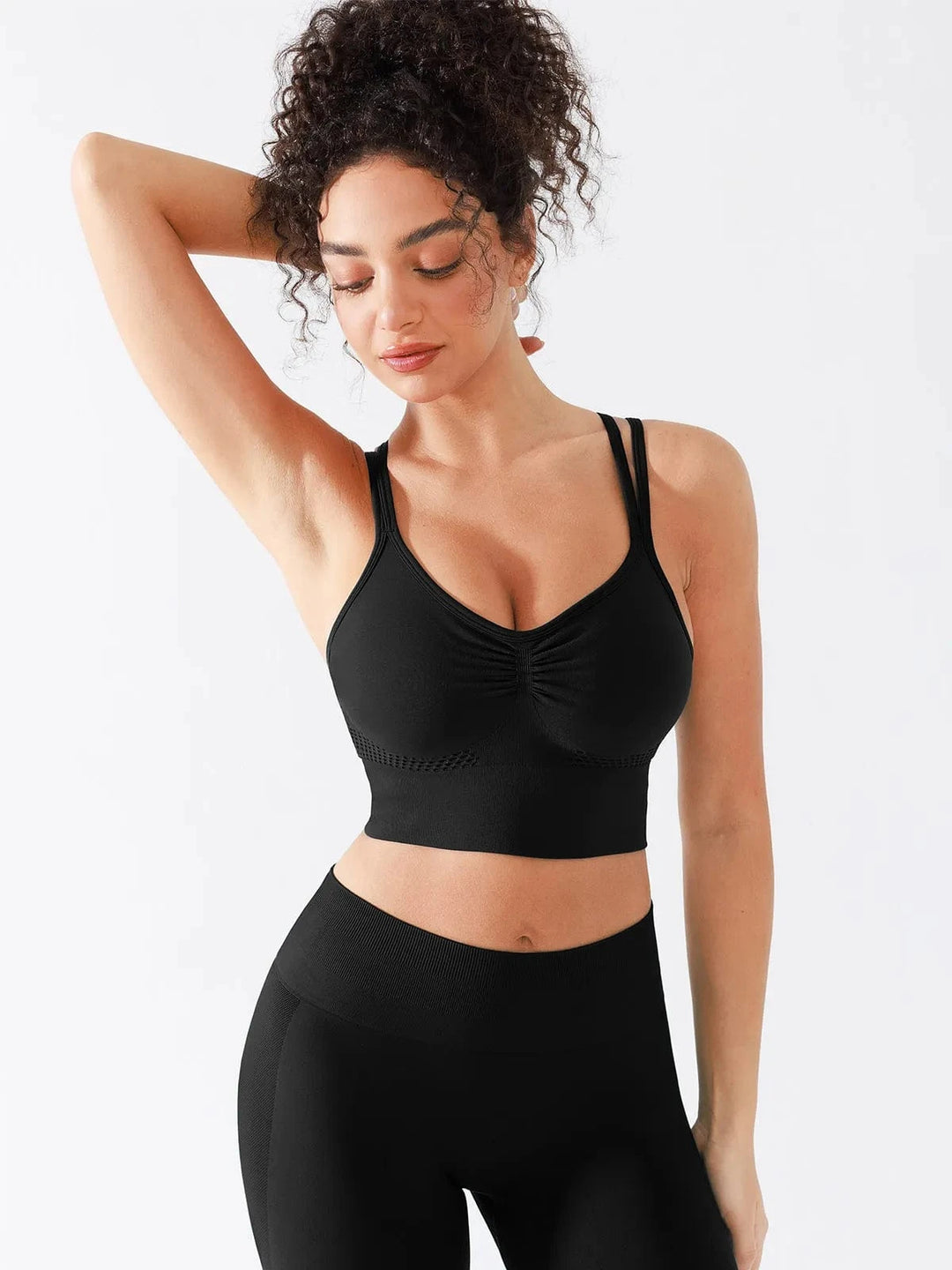 A model wearing a BRXL® Seamless Criss Cross Spaghetti Racerback Sports Bra in