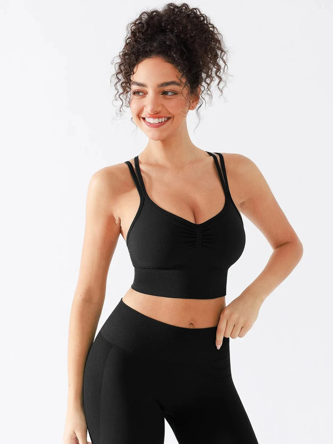 A model wearing a BRXL® Seamless Criss Cross Spaghetti Racerback Sports Bra in