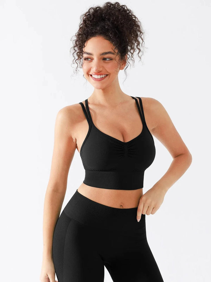 A model wearing a BRXL® Seamless Criss Cross Spaghetti Racerback Sports Bra in