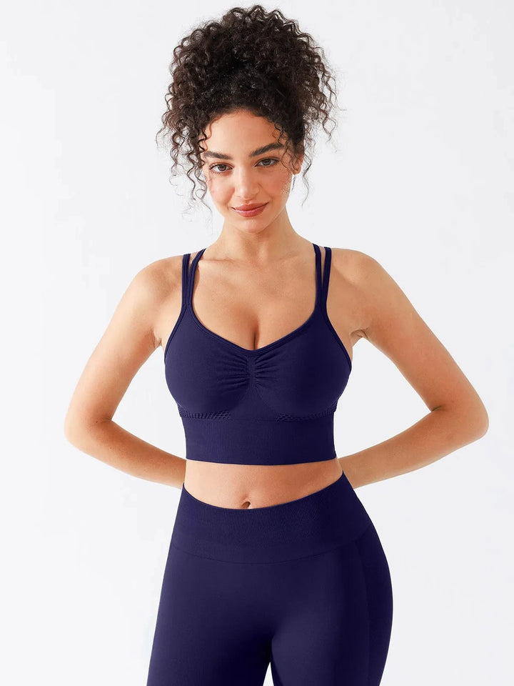 A model wearing a BRXL® Seamless Criss Cross Spaghetti Racerback Sports Bra in