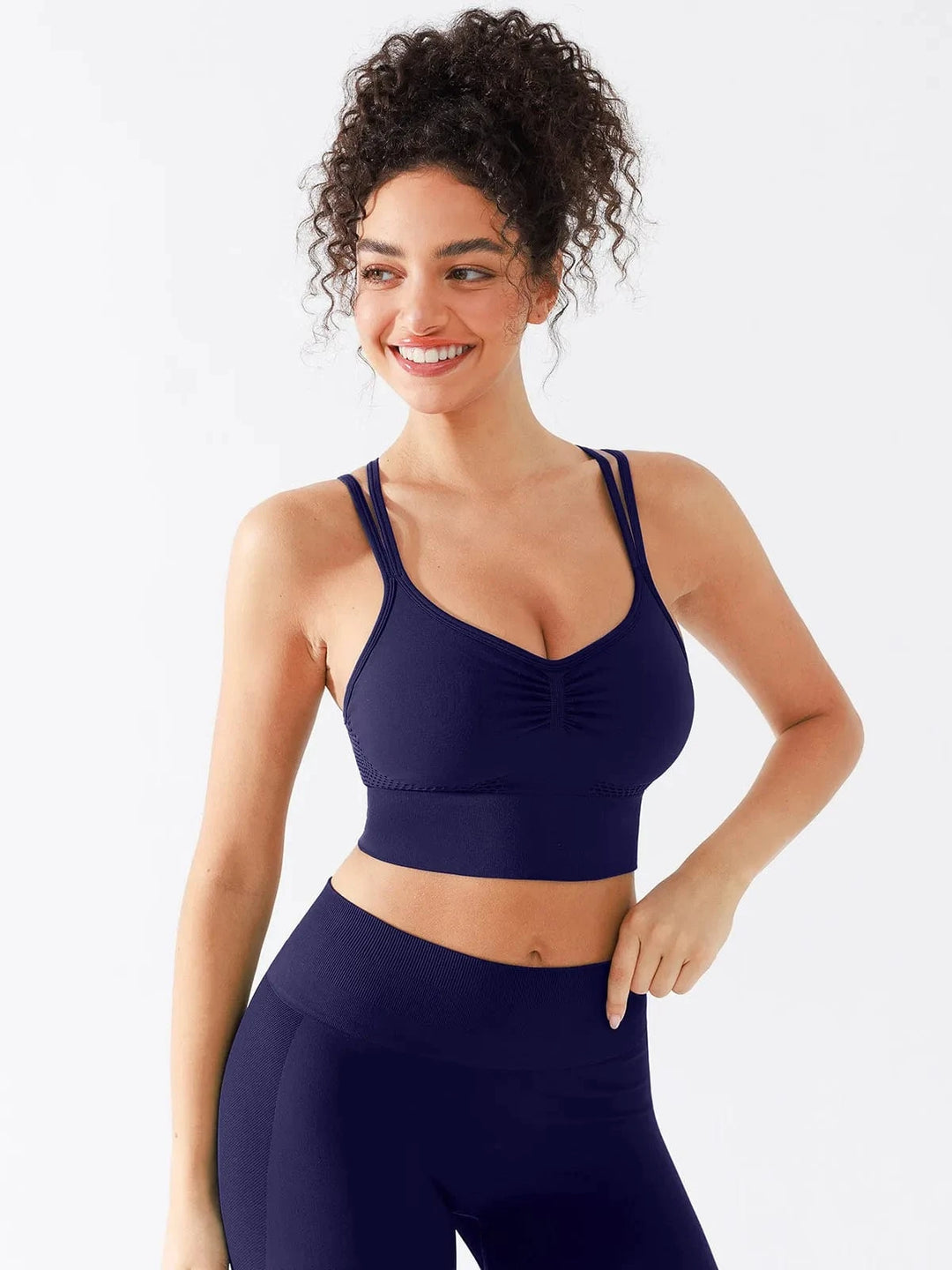 A model wearing a BRXL® Seamless Criss Cross Spaghetti Racerback Sports Bra in