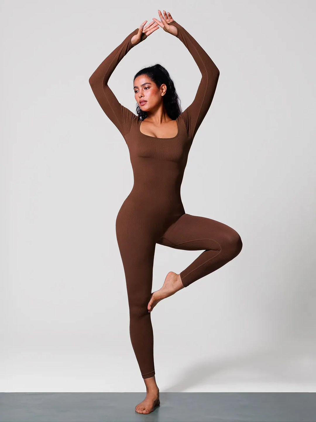 A model wearing a BRXL® Yoga Activewear Jumpsuit Winter Shapewear Long Sleeve Thumb Hole Jumpsuit in
