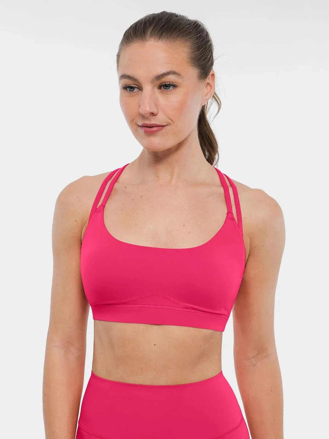 A model wearing a BRXL® Sports Bra Sculpted Shorts Sculpted Leggings Set in