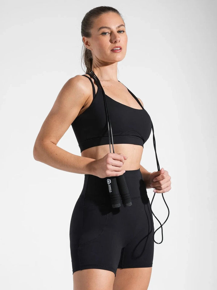 A model wearing a BRXL® Sports Bra Sculpted Shorts Sculpted Leggings Set in