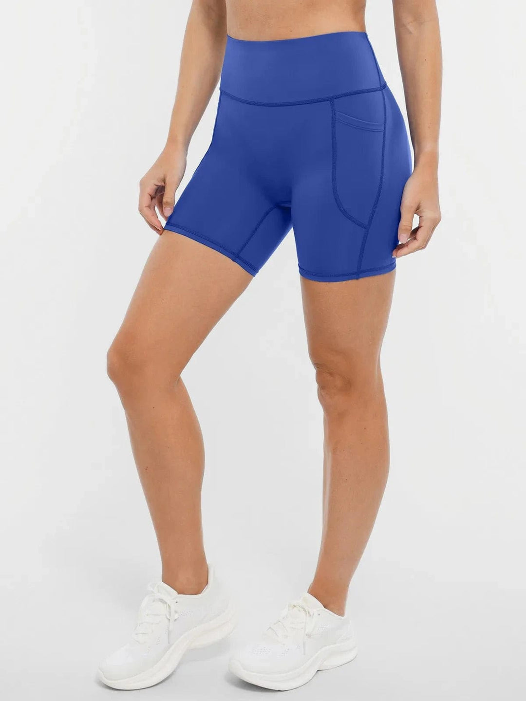 A model wearing a BRXL® Sports Bra Sculpted Shorts Sculpted Leggings Set in