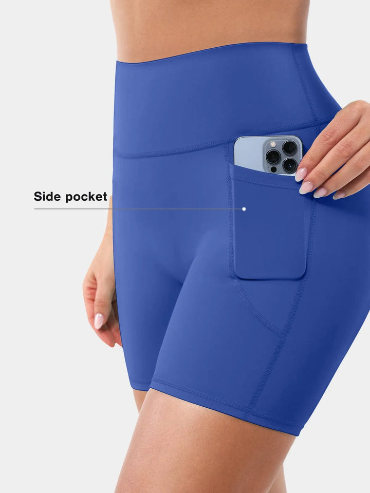 A model wearing a BRXL® Sports Bra Sculpted Shorts Sculpted Leggings Set in