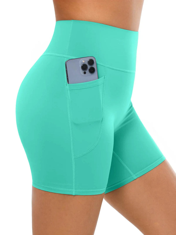 A model wearing a BRXL® Sports Bra Sculpted Shorts Sculpted Leggings Set in Shorts / Mint Green / XS
