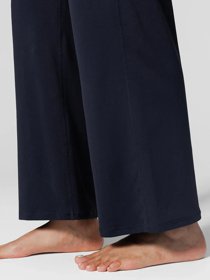 A model wearing a BRXL® Tummy Control Wide Leg Activewear Leggings in